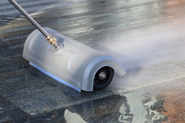 A man effortlessly pushing an innovative floor cleaning tool