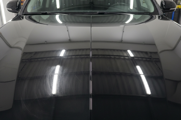 a side-by-side comparison of a paint finish with swirl marks vs a glossy, swirl-free finish