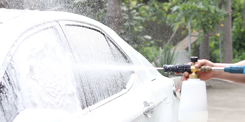 Heavy-duty foam cannon covering an SUV in thick snow foam